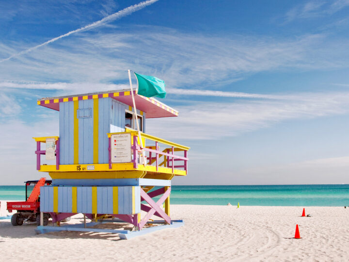 best beach honeymoon destinations in usa Miami Beach lifeguard shack and white sand with teal water in distance