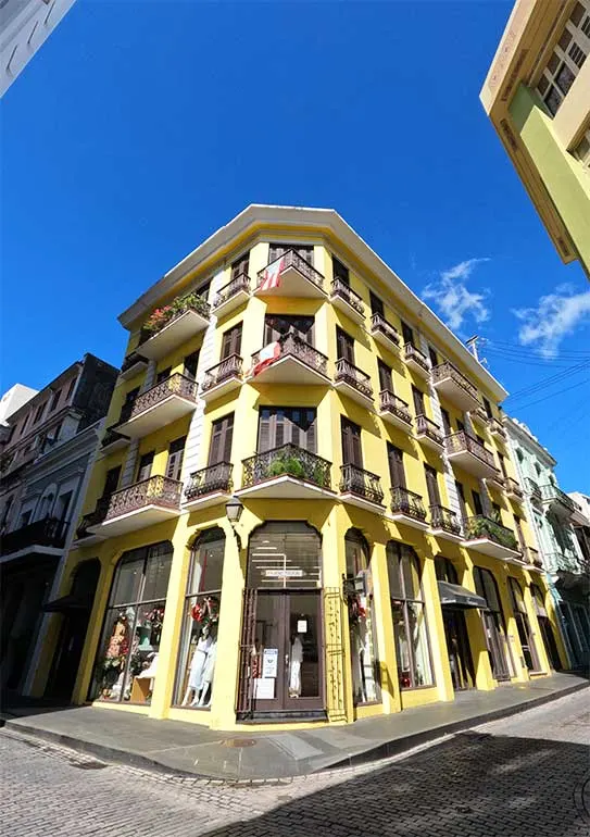yellow building with balconies at each window and door in old san juan