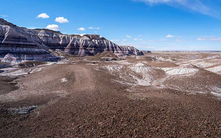 travel in April best places petrified forest brown rocky sand with large striped rocks