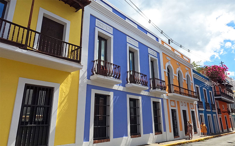 things to do in old San Juan walk the streets look at colorful buildings pic of yellow blue orange buildings