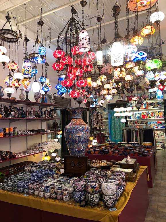best things to do in old San Juan shopping at nighttime store full of lamps and decorative candle holders