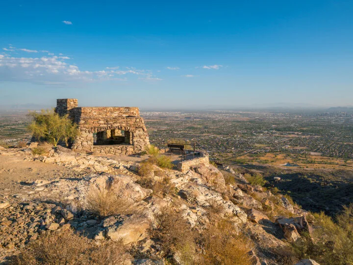 phoenix in 1 day view of ancient scripture on hilltop with city in distance