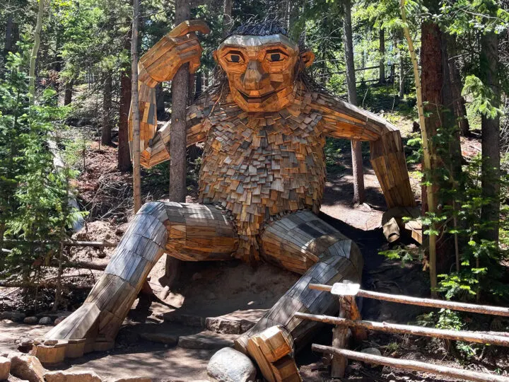 Breckenridge Troll located in Colorado made of recycled wood sitting in the forest
