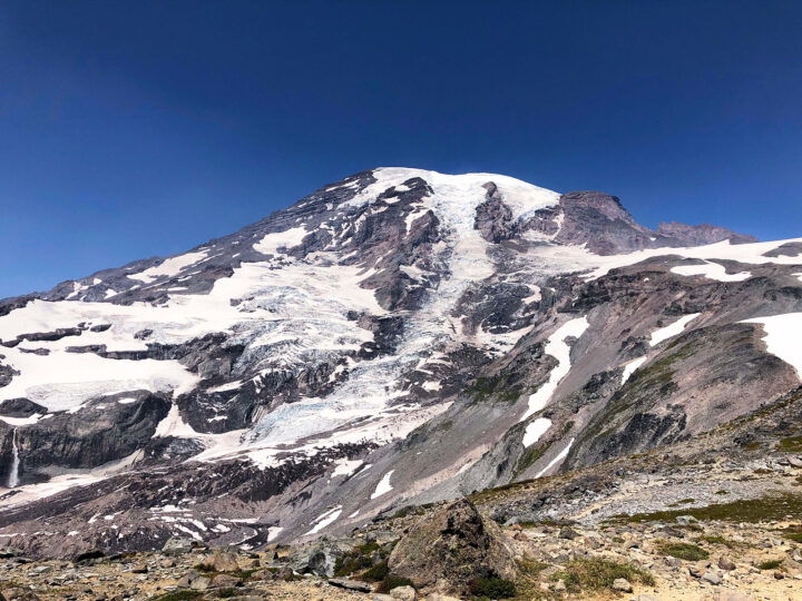 best hikes mt rainier pic of snow and rocky covered mountain with blue sky
