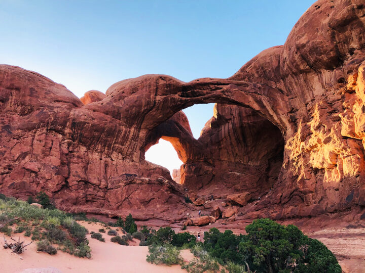 one day in arches national park photo of large arch with red rock and stone all around