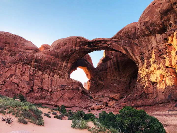 large arch with red rock and stone all around
