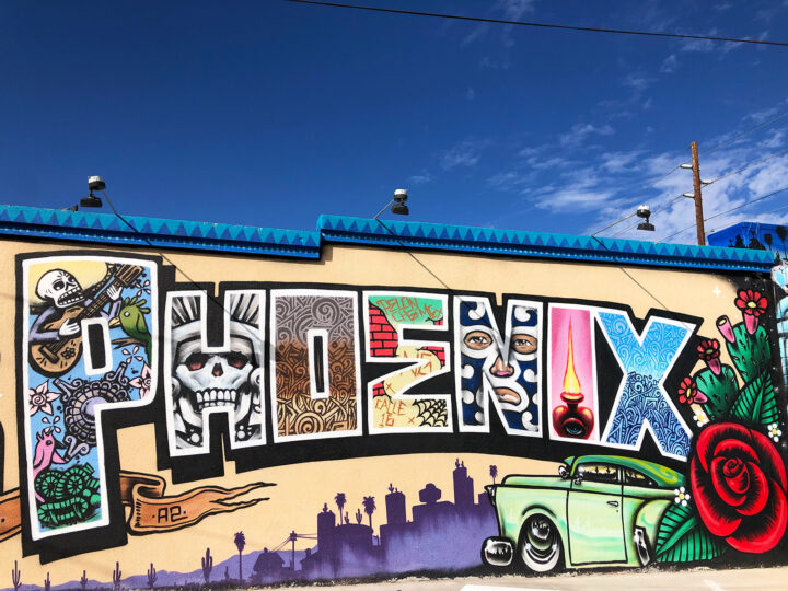 phoenix itinerary - mural of phoenix with each letter a different pattern and car and skyline on side of building