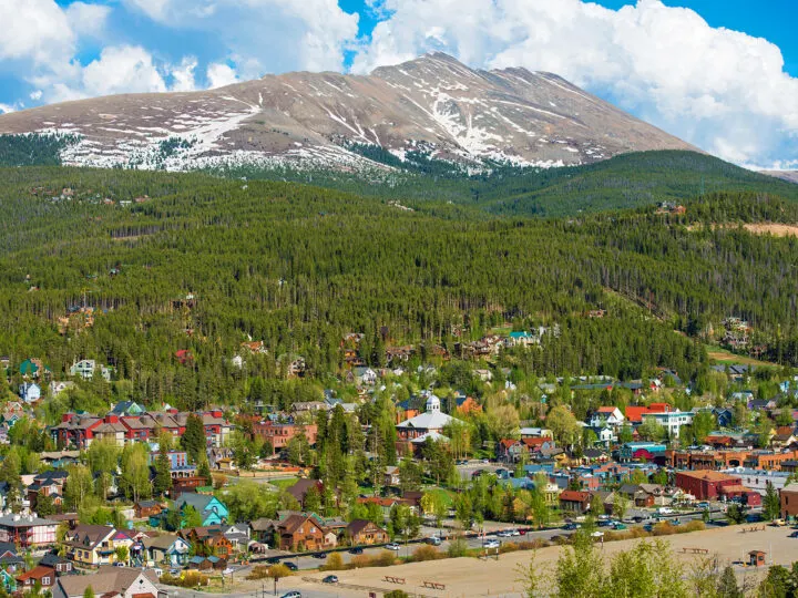 Breckenridge in summer picture of mountain town from a distance with mountain up above
