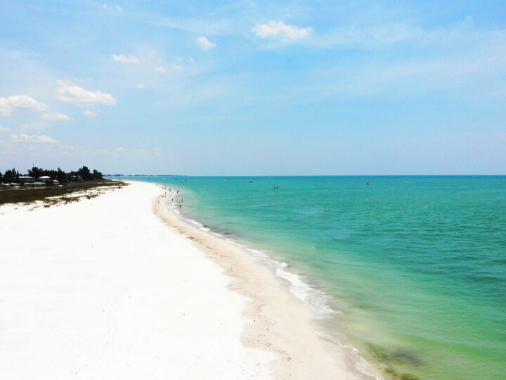 things to do in Anna Maria island go to the beach with white sandy beach with green water