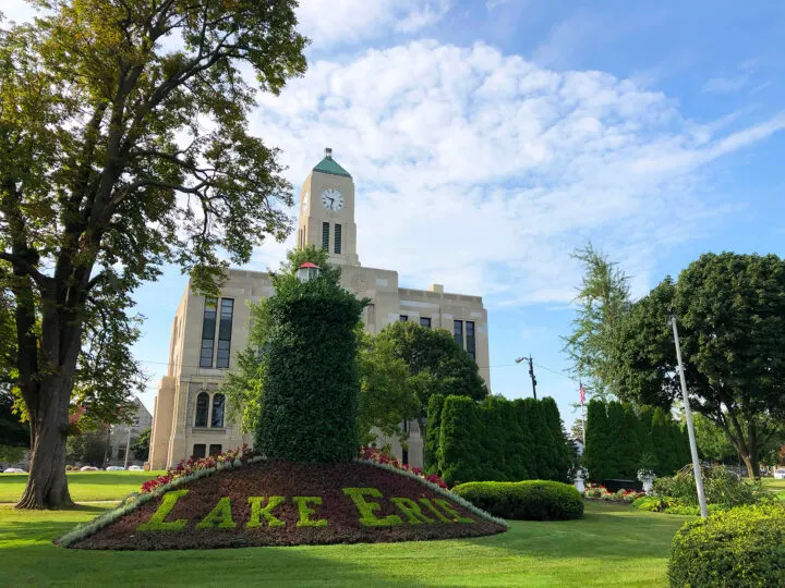 things to do in Sandusky Ohio pic of gov't building with garden in front tres, bushes and Lake Erie carved letters