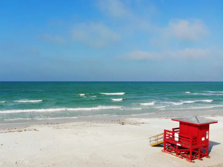 best places to fly drones in the US-Siesta Key view of white sand beach teal water red lifeguard stand