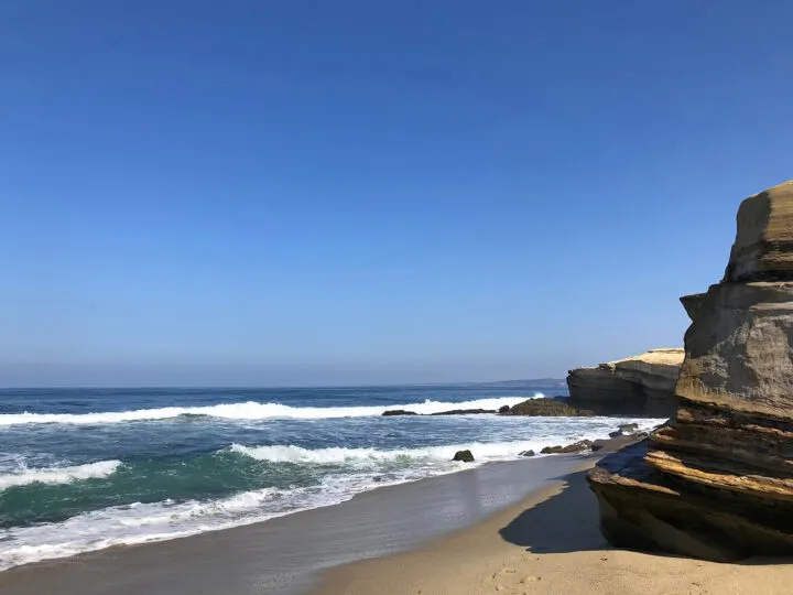 2 days in San Diego spend it on this gorgeous beach with white waves and rock formations blue sky