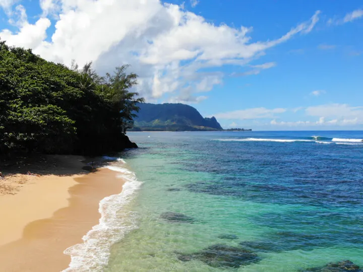 best beaches Kauai Hawaii - picture of small beach with turquoise water and picturesque mountains