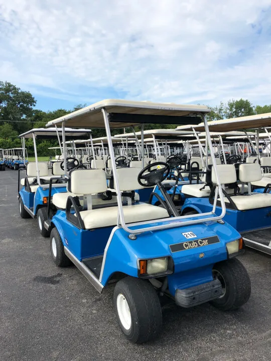 how to get around Kelleys island picture of blue and tan golf cart on sunny day