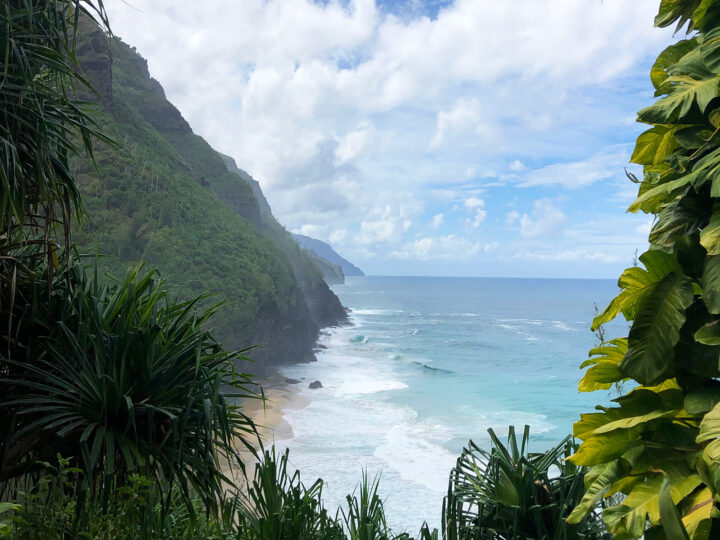 Kalalau trail Kauai picture of scenic coastline blue water rolling coast with greenery on either side