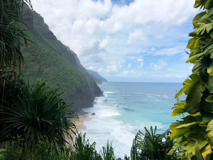 Kalalau trail Kauai picture of scenic coastline blue water rolling coast with greenery on either side