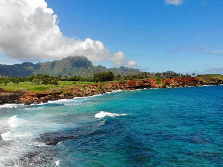 mahaulepu trail kauai picture of blue ocean red rocky coastline mountains with blue sky