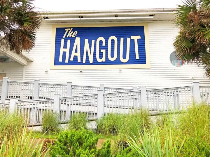 the hangout gulf shores blue sign railing green grass