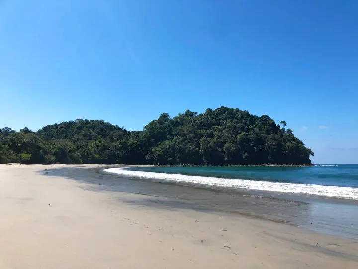 Playa-Espadilla-Sur beautiful sand blue water tree line coast beaches in Manuel Antonio