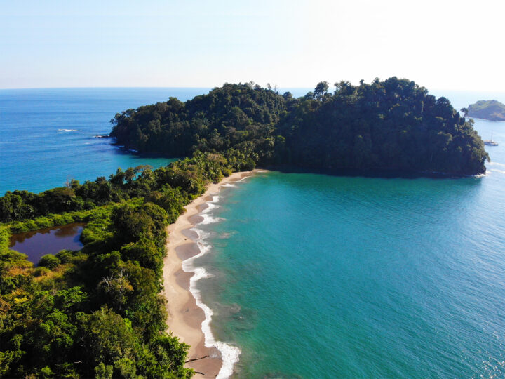 view from above beach in Costa Rica teal water white beaches trees