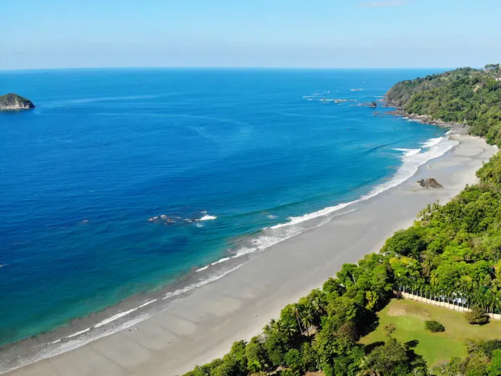 Playa Espadilla pic of white beach trees and blue water