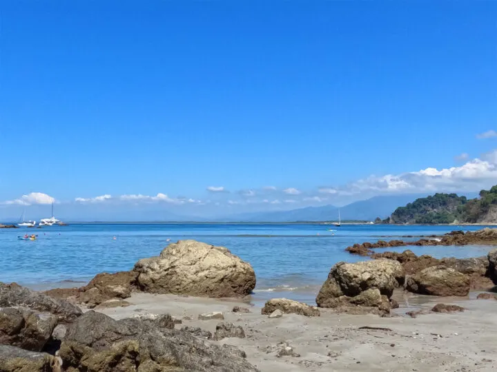 rocky beach grey sand blue water