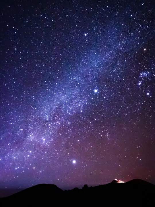 stargazing on Haleakala view of milky way above crater with purple sky