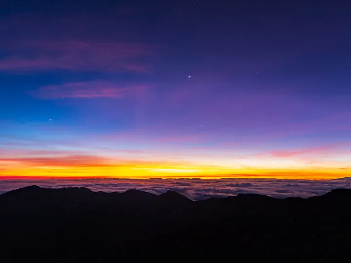 sunrise above the clouds blue sky pink orange purple