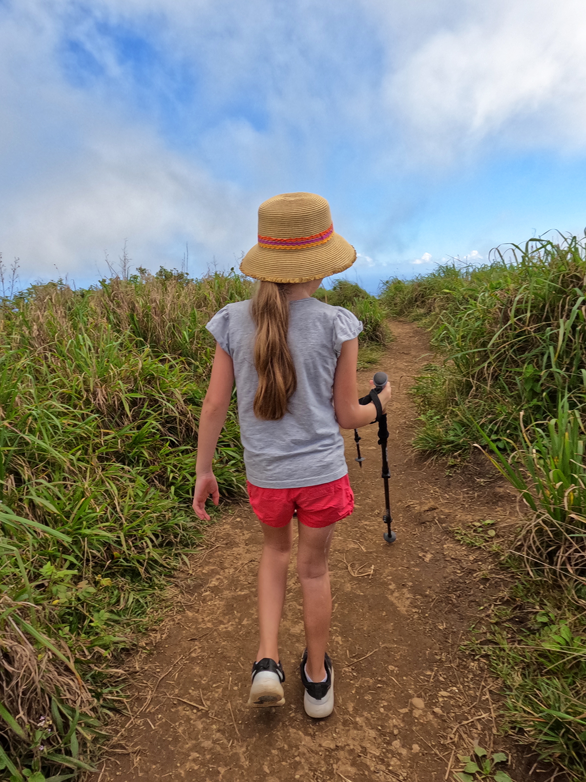 things to do in maui for kids hiking trail girl with long ponytail hikes in wavy grass