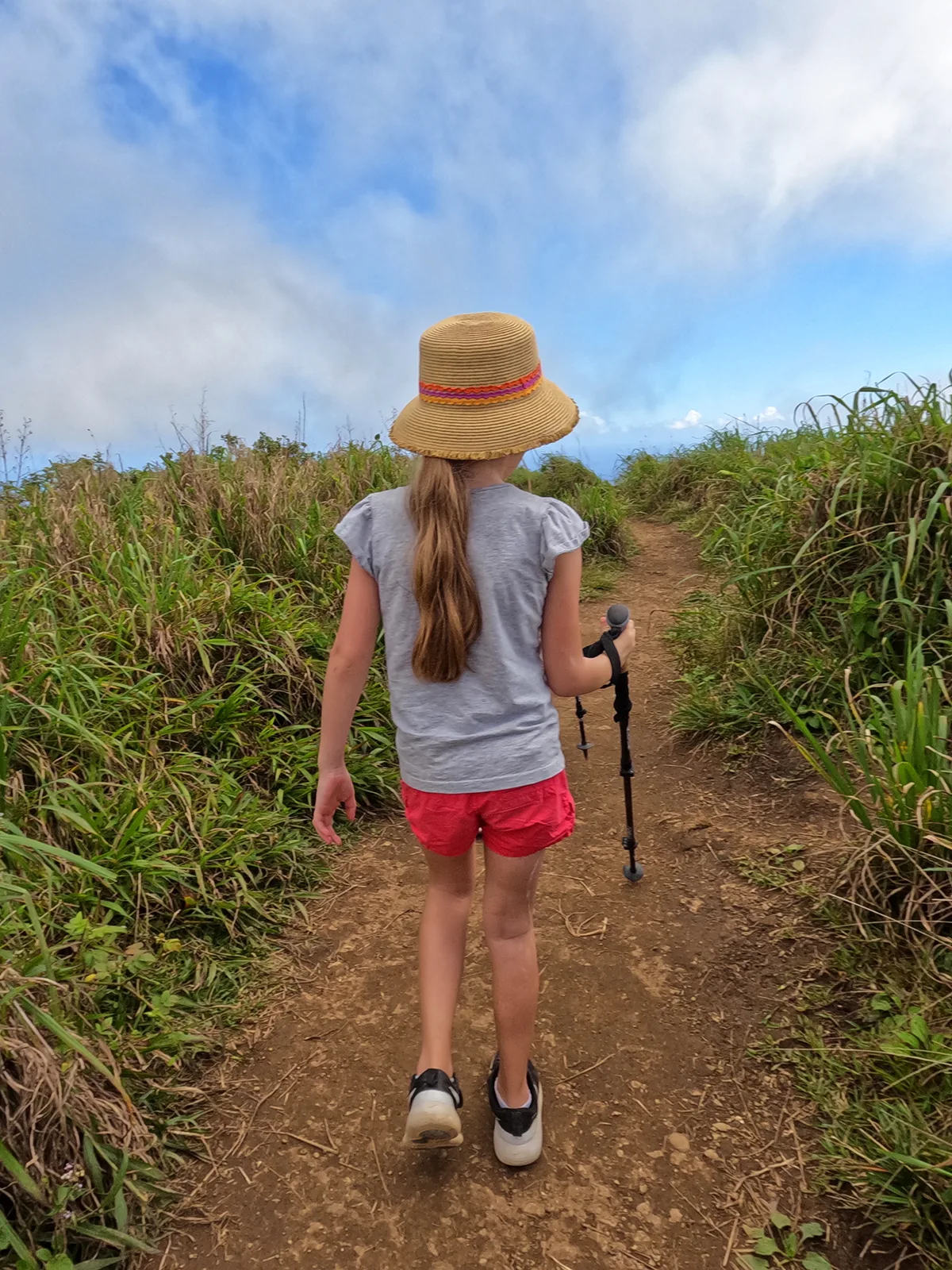 things to do in maui for kids hiking trail girl with long ponytail hikes in wavy grass