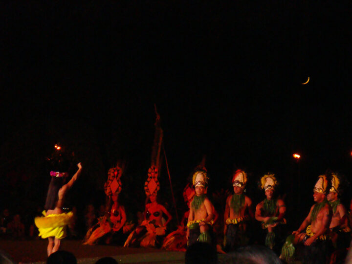 hula dancers women and men in traditional wear during nighttime