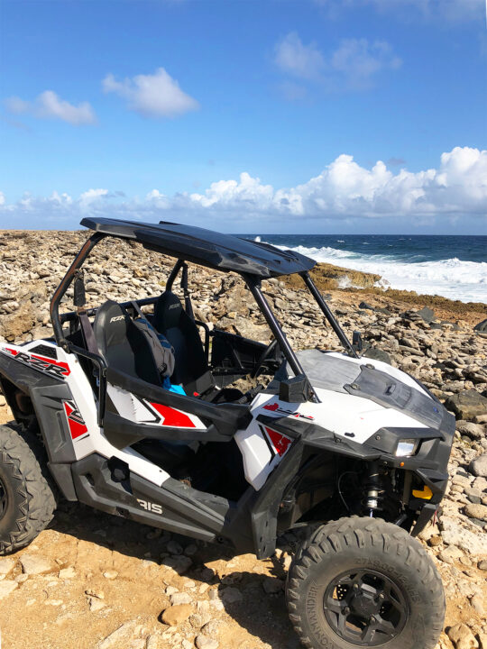 utv tour in maui with side-by-side on rocky beach with ocean in distance