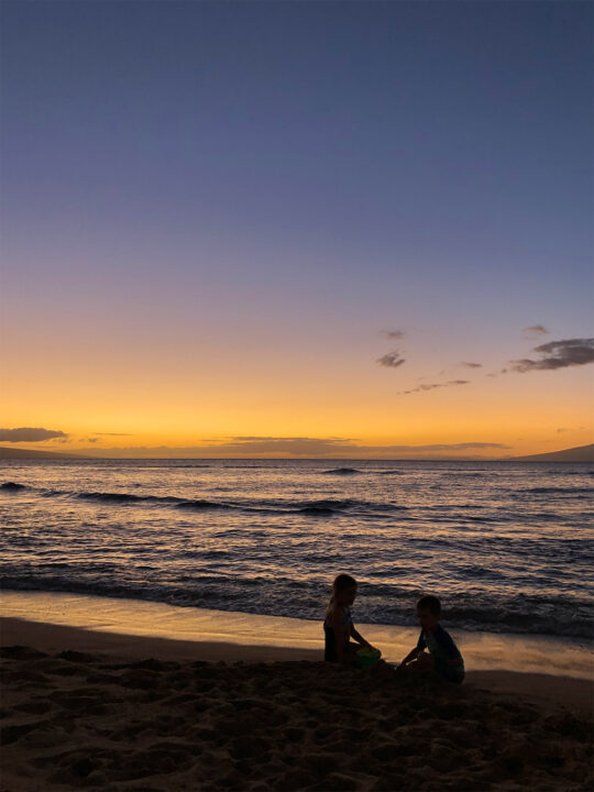 kids activities in maui silhouettes of kids sitting on the beach at sunset
