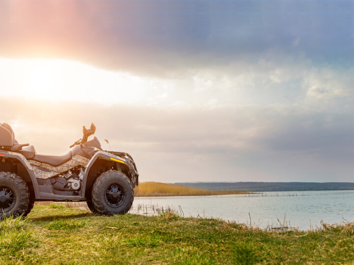 adventure vacations usa view of four wheeler sitting by lake at sunset