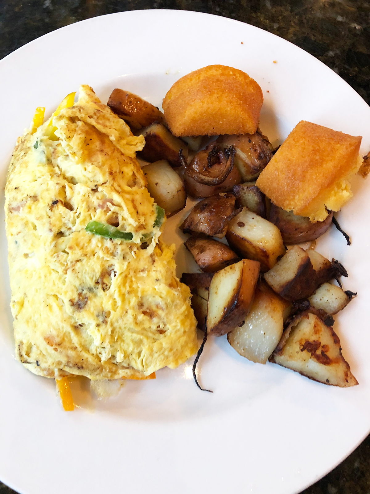 best breakfast kauai omelette potatoes corn bread on white plate