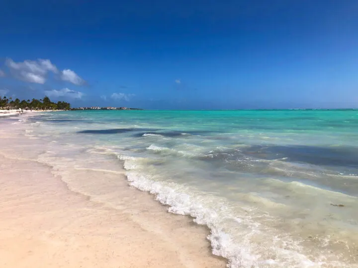 white sand beach ocean wave teal water