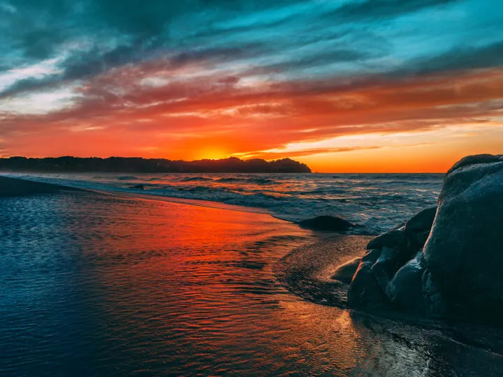 tropical Christmas in Sayulita view of beach at sunset with bright red and blue sky reflecting on sand