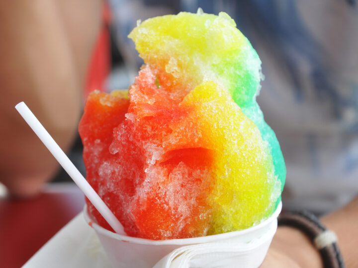 shave ice hawaii with red yellow green in a cup with straw