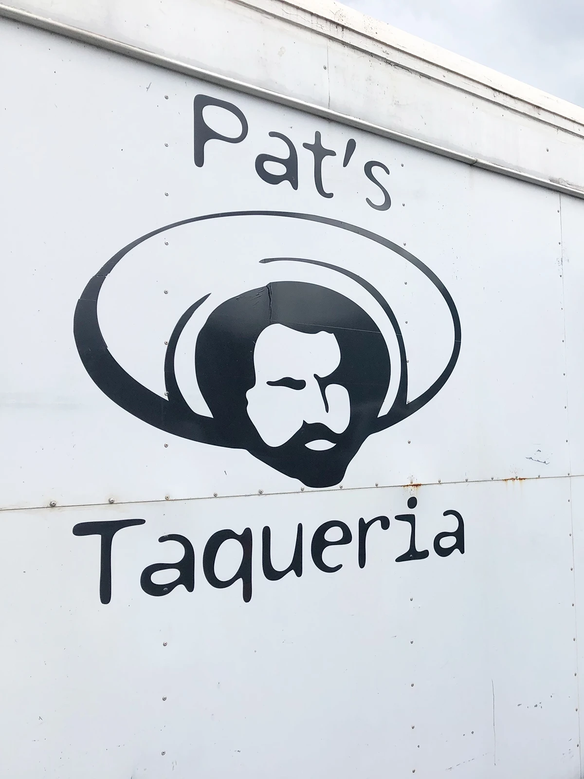 pats taqueria sign with man wearing sombrero