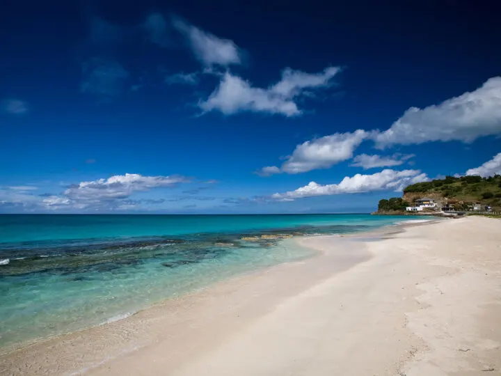 antigua warm vacation in January white sand beach teal water blue sky