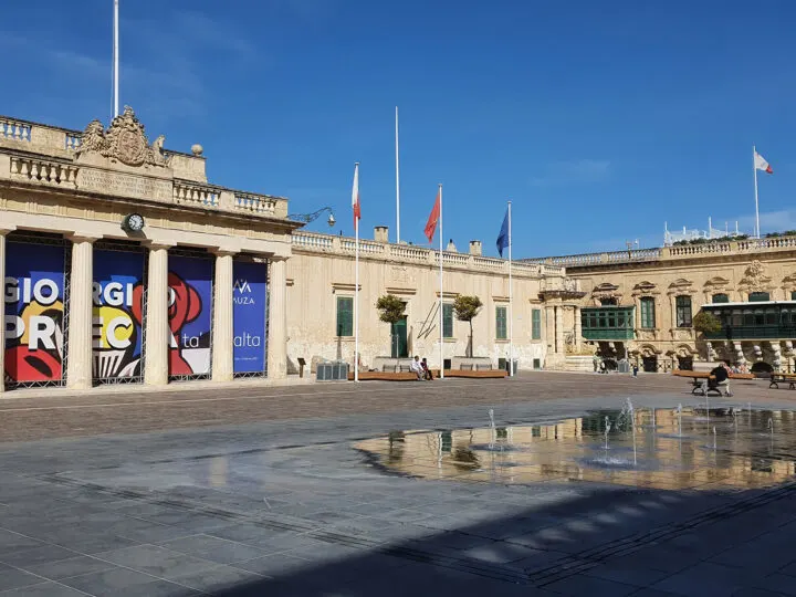 Malta buildings with flags concrete plaza