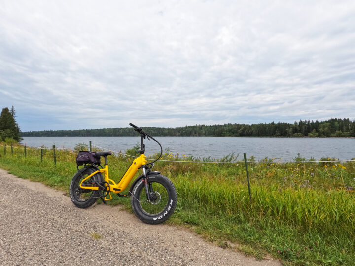 clear lake manitoba yellow bike resting against lake shore
