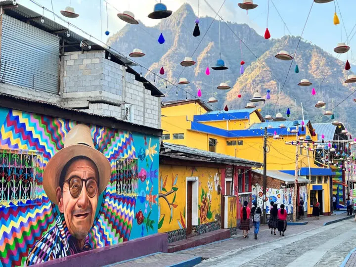 Best countries to visit in January- Guatemala street art murals colorful buildings with mountain in background