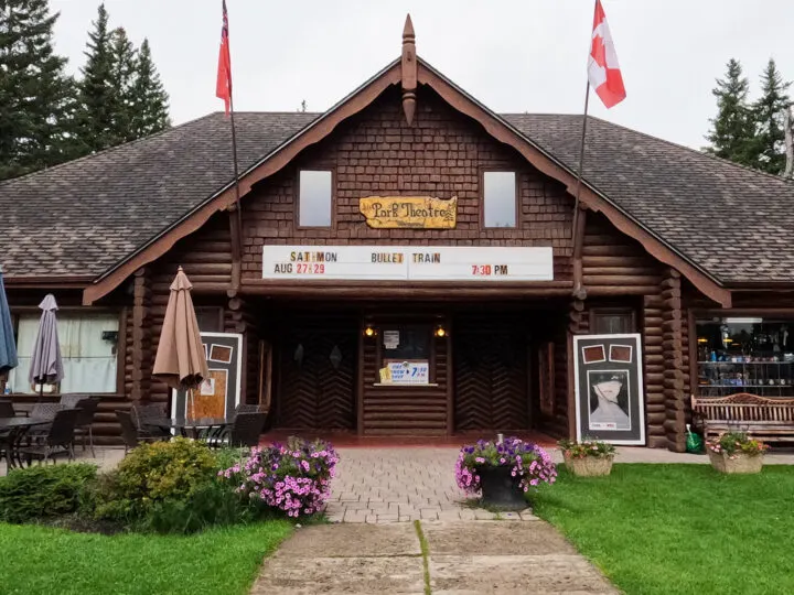 park theatre building entrance with flags signs and flowers