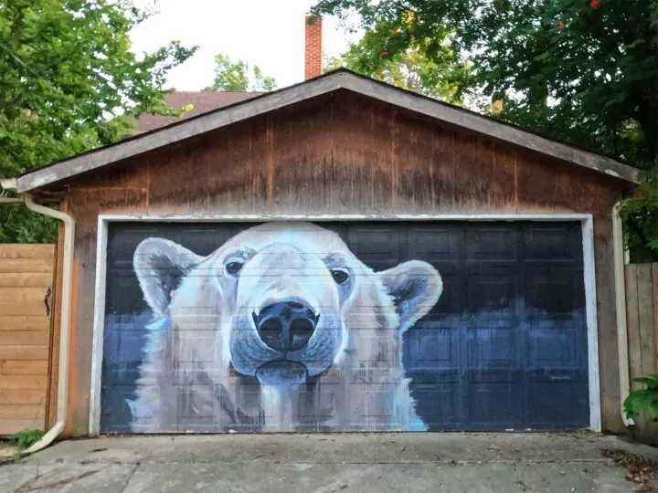 polar bear mural on garage door with wood exterior