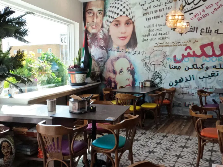 yafa cafe tables mural on wall and plants