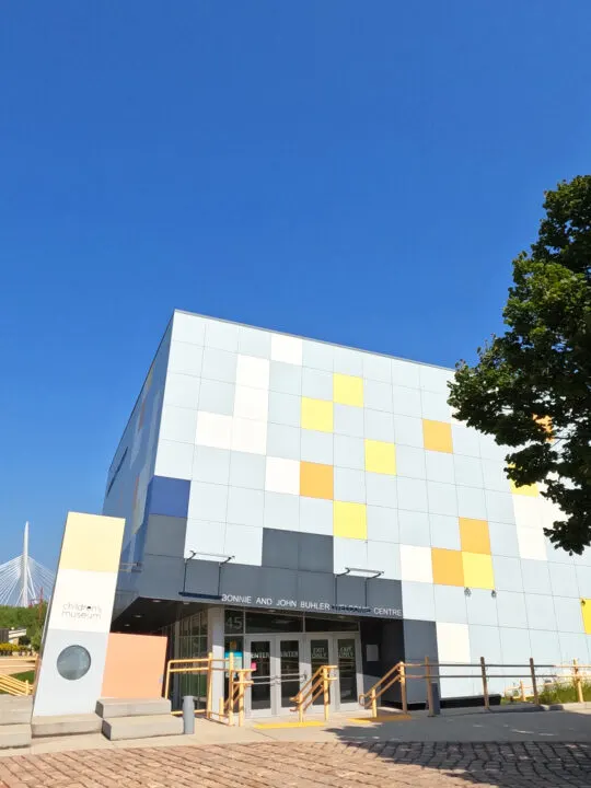 building front with multi colored square glass and entrance on sunny day