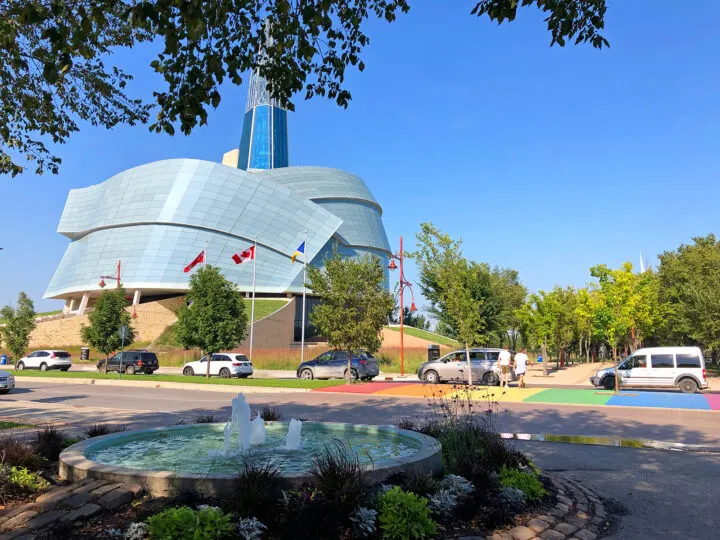 Manitoba vacation view of water fountain multi colored city street and round building