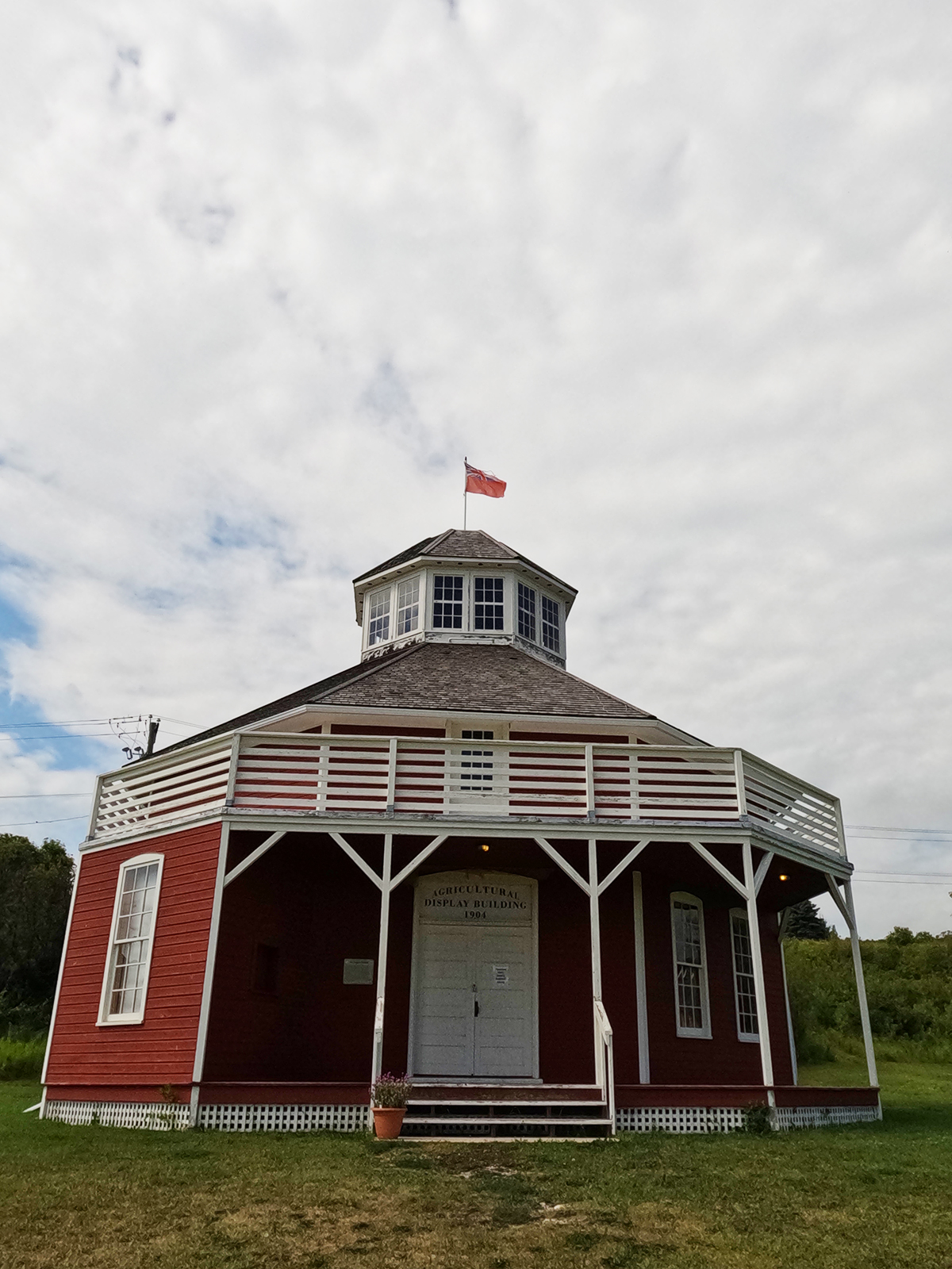 view of octagon shaped house red and white with flag on a manitoba vacation
