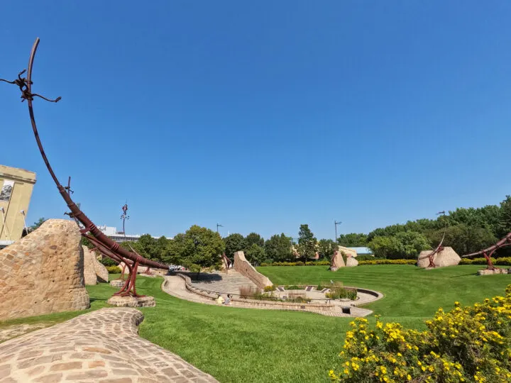 view of sunken courtyard with large metal objects pointing to sky